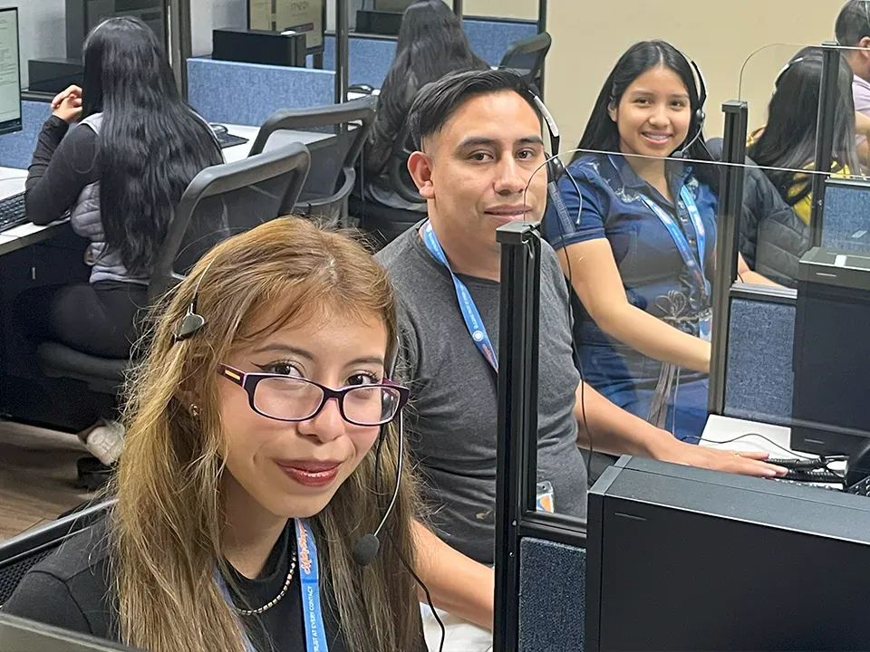 The 14 Degrees team smiling together at their workstations