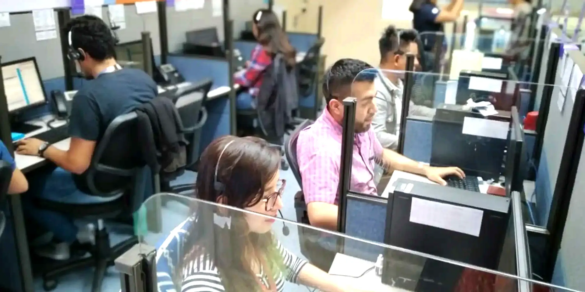 14 Degrees agents with headsets at work on the contact center floor