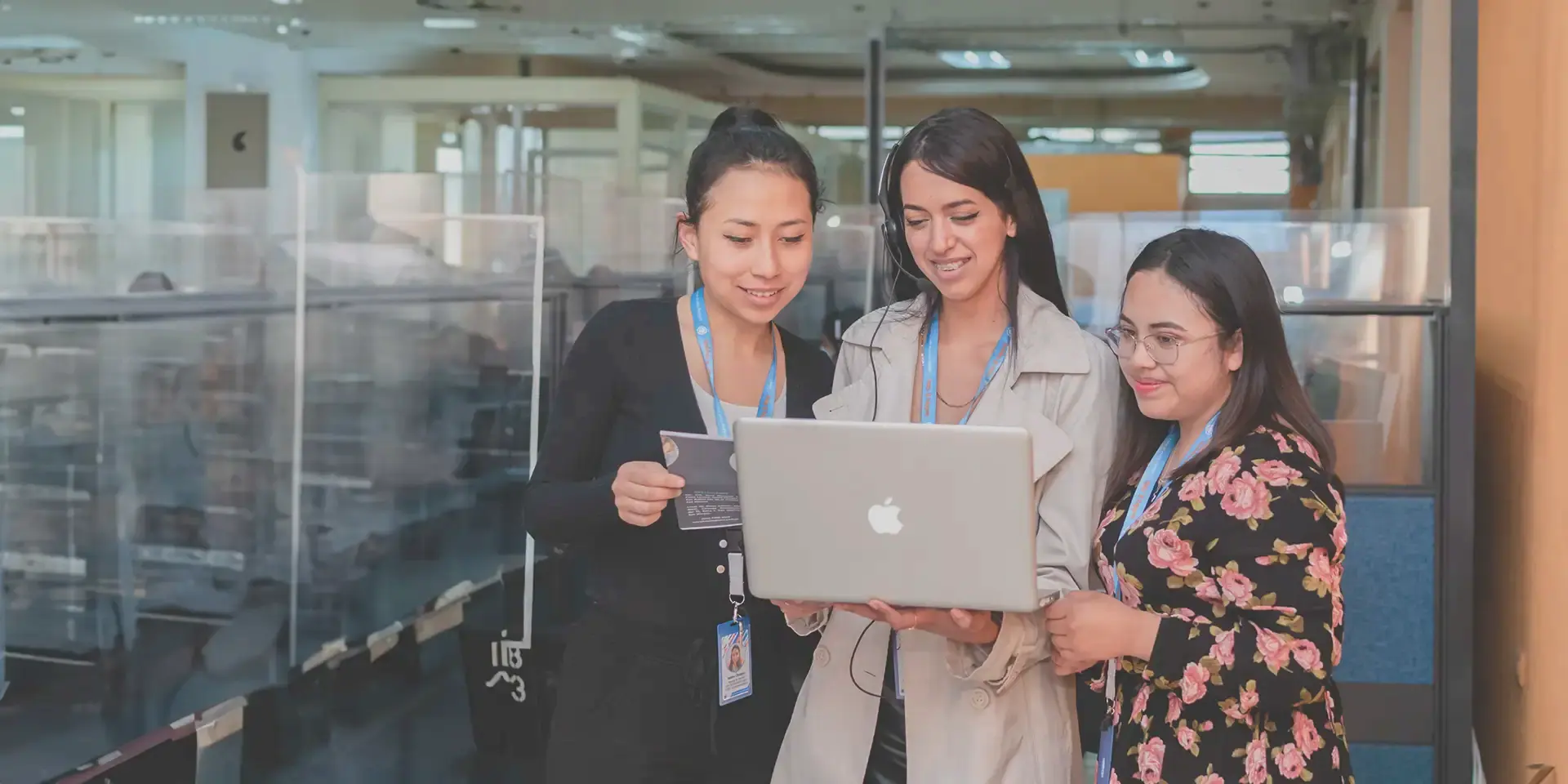 Three team leads reviewing results on a laptop