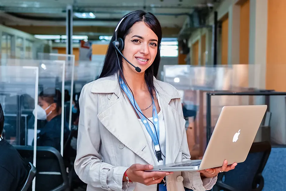 A 14 Degrees executive with a headset and laptop