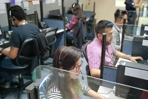 Contact center agents with headsets at their workstations